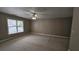 Spacious bedroom with neutral carpet, ceiling fan, and a large window for natural light at 2604 Harman Park Cir, Duluth, GA 30097