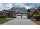 Charming brick home with manicured landscaping, a driveway, and an attached two-car garage at 2604 Harman Park Cir, Duluth, GA 30097