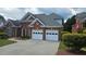 Charming brick home with manicured landscaping, a driveway, and an attached two-car garage at 2604 Harman Park Cir, Duluth, GA 30097