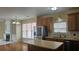 Kitchen with stainless steel appliances, island, and adjacent fireplace room at 2604 Harman Park Cir, Duluth, GA 30097