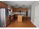 Bright kitchen features stainless steel appliances, wood cabinets, tile backsplash, a kitchen island, and hardwood floors at 2604 Harman Park Cir, Duluth, GA 30097