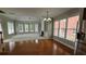 Expansive living room with natural light and a fireplace, seamlessly flowing from the hardwood dining area at 2604 Harman Park Cir, Duluth, GA 30097