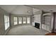 Bright living room features a fireplace, built-in shelving, a ceiling fan, and a large bay window at 2604 Harman Park Cir, Duluth, GA 30097