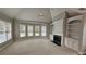Spacious living room with a fireplace, built-in cabinets, and a large bay window at 2604 Harman Park Cir, Duluth, GA 30097