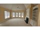 Living room with a fireplace, large bay windows, carpet, and built-in shelving at 2604 Harman Park Cir, Duluth, GA 30097
