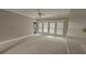 Living room with neutral carpet and a row of windows bringing in lots of natural light at 2604 Harman Park Cir, Duluth, GA 30097