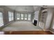 Bright living room features a fireplace, built-in shelving, a ceiling fan, and a large bay window at 2604 Harman Park Cir, Duluth, GA 30097