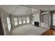 Bright living room features a fireplace, built-in shelving, a ceiling fan, and a large bay window at 2604 Harman Park Cir, Duluth, GA 30097