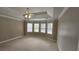 Spacious main bedroom with tray ceiling, ceiling fan, and bay window offering ample natural light at 2604 Harman Park Cir, Duluth, GA 30097