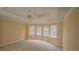 Bright main bedroom features a trey ceiling, large windows, and neutral carpet at 2604 Harman Park Cir, Duluth, GA 30097