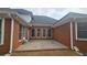 An exterior view of the brick patio featuring an overhang and several windows at 2604 Harman Park Cir, Duluth, GA 30097