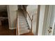 Inviting staircase with hardwood and carpet leading to an open living area at 2604 Harman Park Cir, Duluth, GA 30097