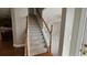 Carpeted stairway with wooden handrails that leads to the upper level of the home at 2604 Harman Park Cir, Duluth, GA 30097