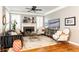 Warm living room featuring hardwood floors, plantation shutters, and a stunning fireplace at 1064 Lena Nw St, Atlanta, GA 30314