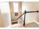 Carpeted staircase with white spindles, black railing, and natural light from window at 1064 Lena Nw St, Atlanta, GA 30314