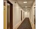 Long hallway featuring neutral paint, base trim, and carpet that leads to various suite entrances at 260 18Th Nw St # 10302, Atlanta, GA 30363