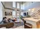 Comfortable living room with tall ceilings, a modern sofa, city artwork, and large windows at 260 18Th Nw St # 10302, Atlanta, GA 30363