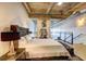 Spacious main bedroom with a plush bed, tufted ottoman, and hardwood floors at 260 18Th Nw St # 10302, Atlanta, GA 30363