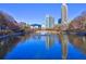 Pond view with fountain reflecting the skyline, showcasing a peaceful community at 260 18Th Nw St # 10302, Atlanta, GA 30363