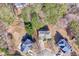 Aerial view of a home surrounded by mature trees and well-manicured lawns at 3637 Green Pine Way, Suwanee, GA 30024