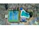 Aerial photo of tennis courts, pool, and picnic pavilion in a wooded community at 3637 Green Pine Way, Suwanee, GA 30024