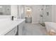 Bright bathroom with gray cabinets, double sinks, a white countertop, and a glass-enclosed shower at 3637 Green Pine Way, Suwanee, GA 30024