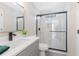 Bathroom with a gray vanity, a sink, a mirror, and a glass-enclosed shower with marble tile at 3637 Green Pine Way, Suwanee, GA 30024