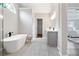 Spacious bathroom with a soaking tub, gray cabinets with white countertop, and access to the main bedroom at 3637 Green Pine Way, Suwanee, GA 30024