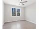 This bedroom provides a ceiling fan, neutral paint, and a view of the outdoors at 3637 Green Pine Way, Suwanee, GA 30024