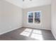 Bedroom with hardwood floors, a neutral wall color, and natural light from the window at 3637 Green Pine Way, Suwanee, GA 30024
