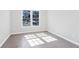 Sunlit bedroom featuring hardwood floors, a large window, and fresh paint at 3637 Green Pine Way, Suwanee, GA 30024
