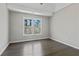 Clean bedroom with hardwood floors, fresh paint, and a window overlooking the woods at 3637 Green Pine Way, Suwanee, GA 30024