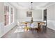 Bright dining room with hardwood floors, large windows, and a modern chandelier at 3637 Green Pine Way, Suwanee, GA 30024