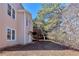 Two-story home with a side door and a staircase leading to a balcony with natural light at 3637 Green Pine Way, Suwanee, GA 30024
