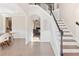 Elegant foyer with hardwood floors, wainscoting and staircase with iron balusters at 3637 Green Pine Way, Suwanee, GA 30024