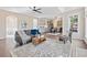 Open-concept living room and kitchen area with hardwood floors and modern furnishings at 3637 Green Pine Way, Suwanee, GA 30024