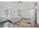 Bright main bedroom with large windows, ceiling fan and tray ceiling at 3637 Green Pine Way, Suwanee, GA 30024