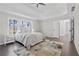 The primary bedroom features a trey ceiling, neutral decor, and a view of the outdoors at 3637 Green Pine Way, Suwanee, GA 30024