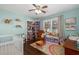 Bright, cheerful bedroom with hardwood floors, pastel walls, and ample play space at 4101 Spring Meadow Rd, Tucker, GA 30084