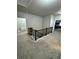 Second floor landing with gray carpet and stairway access to the first floor at 5215 Tye Trl, Fairburn, GA 30213