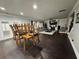 Open concept living and dining area showing fireplace, TV, hardwood floors and lots of light at 5215 Tye Trl, Fairburn, GA 30213