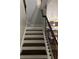 Stairway with hardwood steps and iron railing leading to upper or lower level at 5215 Tye Trl, Fairburn, GA 30213