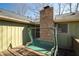 Back porch features a swing and brick chimney creating a cozy outdoor space at 1312 La Mesa Dr, Lawrenceville, GA 30043