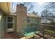 Back porch features a swing and brick chimney creating a cozy outdoor space at 1312 La Mesa Dr, Lawrenceville, GA 30043