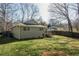 Well-manicured backyard with lush green lawn, trees, and the home's exterior at 1312 La Mesa Dr, Lawrenceville, GA 30043