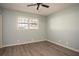 Well-lit room with new floors, neutral walls, and a ceiling fan that creates a calm and inviting atmosphere at 1312 La Mesa Dr, Lawrenceville, GA 30043