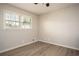 Bright, neutral bedroom featuring a ceiling fan, new flooring, and a large window for natural light at 1312 La Mesa Dr, Lawrenceville, GA 30043