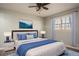 Comfortable bedroom featuring a ceiling fan, a soothing color palette, and a picturesque ocean-themed wall art at 1312 La Mesa Dr, Lawrenceville, GA 30043