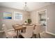 Inviting dining room features a modern chandelier and a wood table set for six at 1312 La Mesa Dr, Lawrenceville, GA 30043