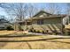 Charming home features manicured landscaping with decorative shrubs, a well-maintained lawn, and walkway to the front entrance at 1312 La Mesa Dr, Lawrenceville, GA 30043